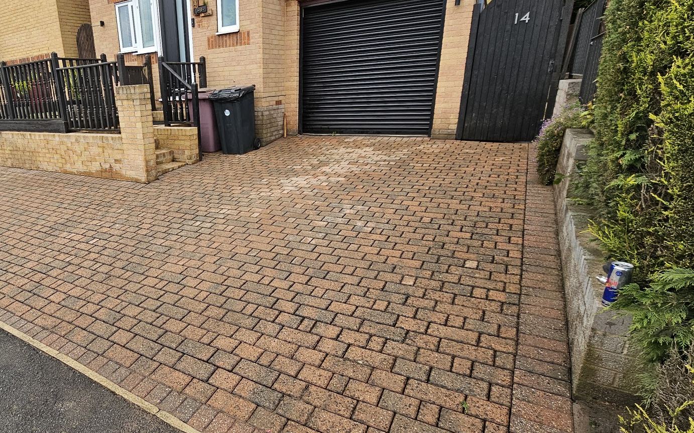 A block paving driveway cleaned and re sanded, colour fully restored