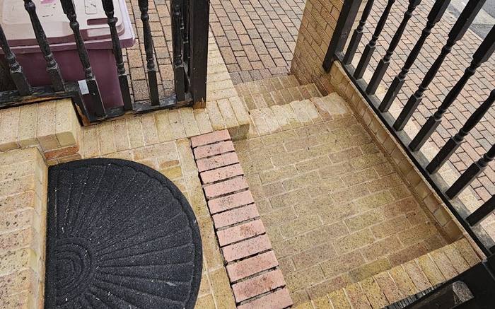 The same brick paved steps and porch cleaned back to their original colour