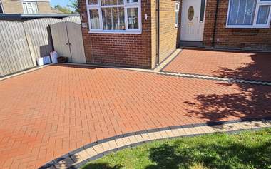 Bungalow block paving driveway pressure washed back to a deep red colour