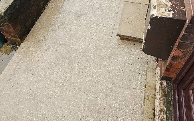 A concrete patio cleaned back to bare concrete